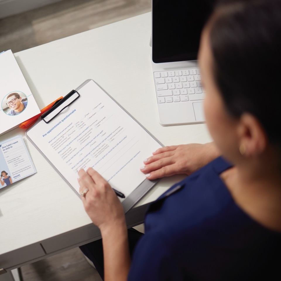 Dental professional looking at papers on a desk